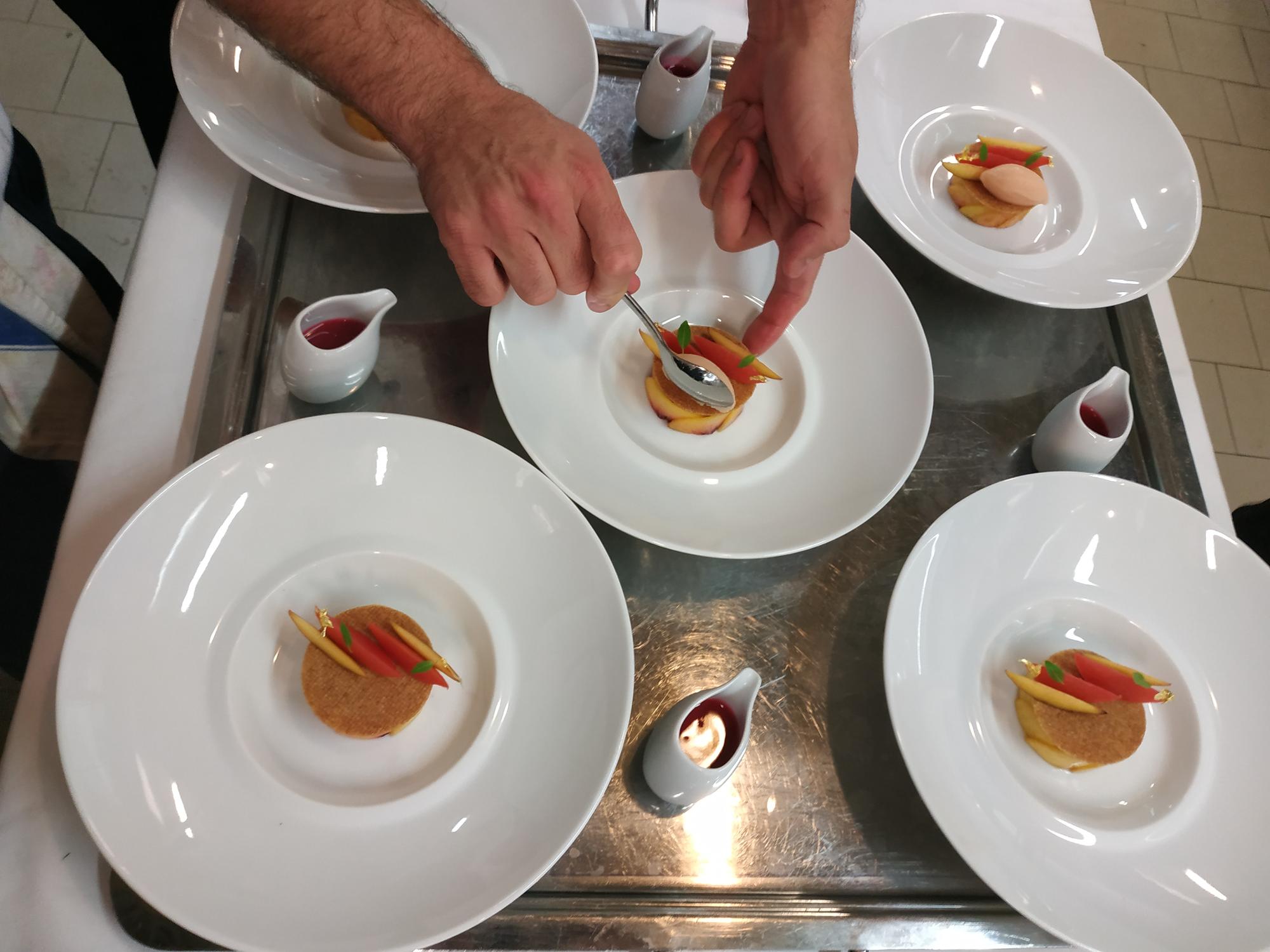 Small team preparing plates in an atelier kitchen